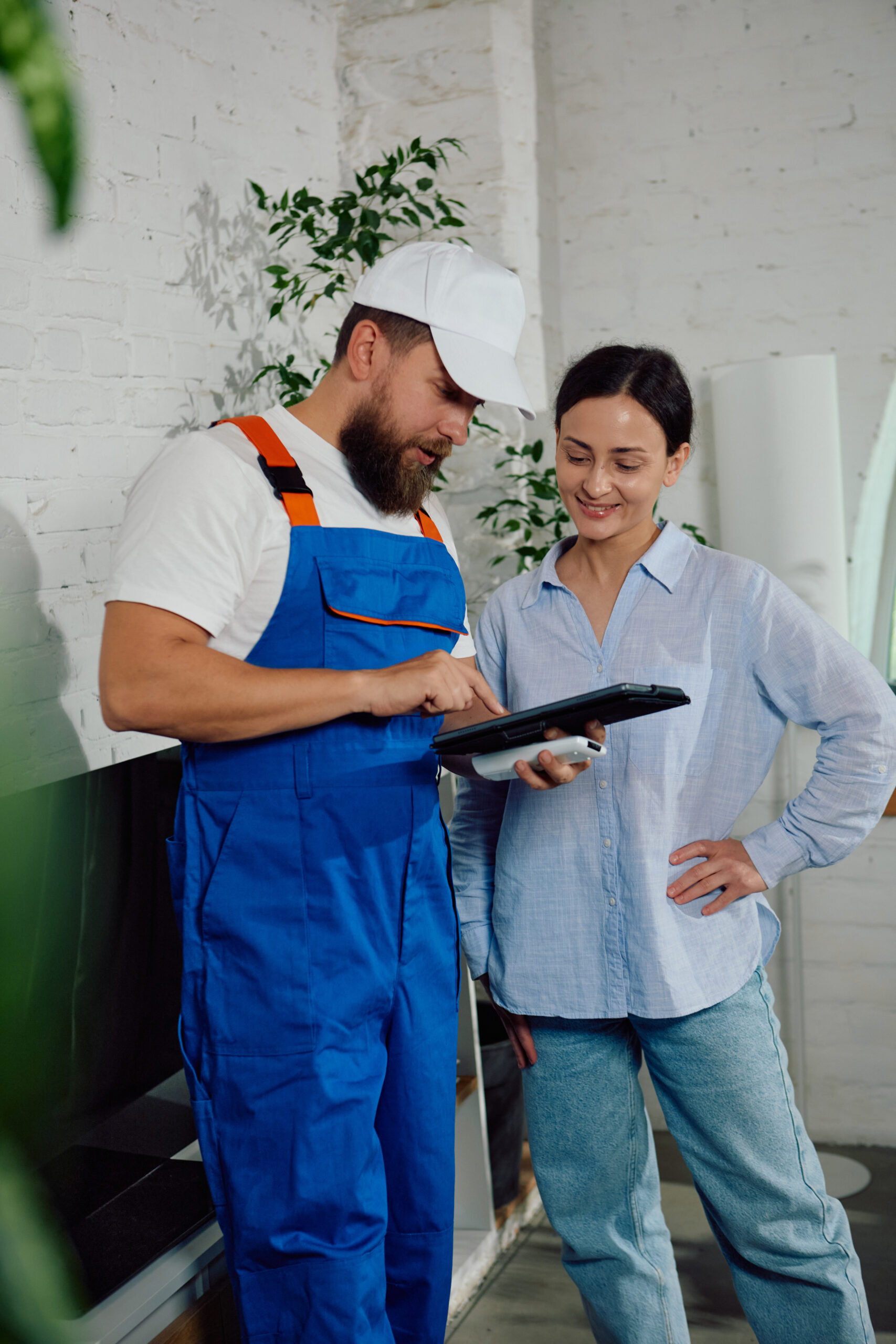 Adobe Stock image of a technician discussing a warranty with a homeowner.